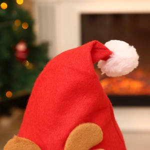 Classic red Christmas hat with white pom-pom and brown reindeer antlers for festive decor