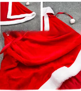 Detail of red velvet Christmas cape showing plush white trim and premium fabric texture