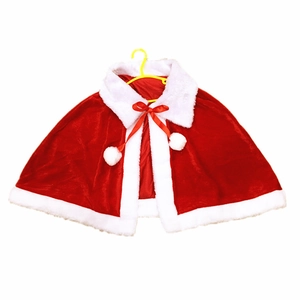 Close-up of Christmas velvet cape with faux fur trim and white pom-pom ribbon detail