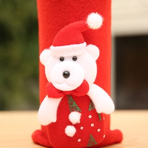 Detail of Christmas wine bottle cover with a plush 3D white bear and festive red felt fabric