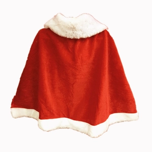 Detail of red velvet Christmas cloak with white faux fur trim and soft flannel texture
