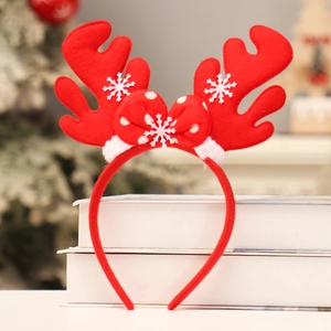 Christmas reindeer antler headband with festive bow and snowflakes on holiday background