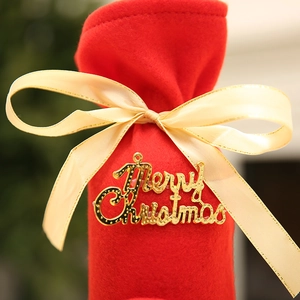 Red felt Christmas wine bottle gift bag with a golden bow and Merry Christmas sign