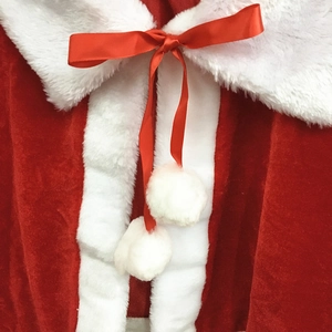 Red velvet Christmas cape with white plush trim and ribbon bow with pom-poms