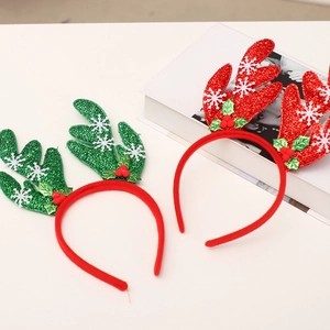 Close-up of red and green sequin reindeer headbands with festive holly and berry details