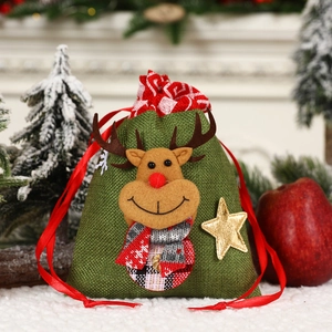 Detail of green burlap Christmas gift bag featuring 3D reindeer with red plaid scarf