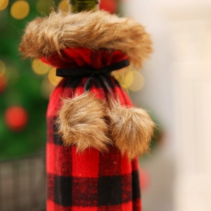Christmas red and black buffalo plaid wine bottle cover with brown faux fur trim and pom-poms