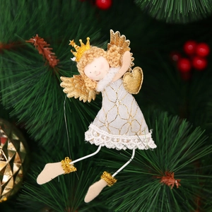 White Christmas angel ornament with golden wings and heart hanging on a festive Xmas tree