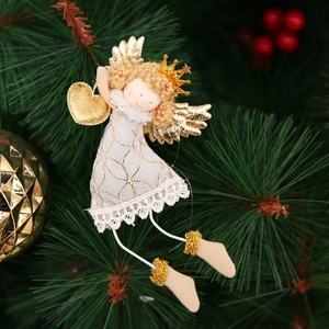 Detail of white and gold Christmas angel ornament with lace dress on a tree