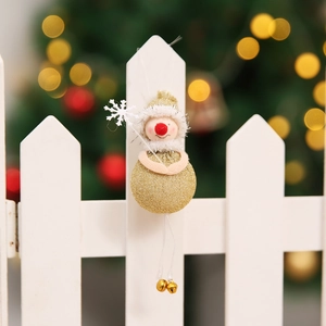 Detailed view of a gold Christmas angel doll ornament with white wand and bells
