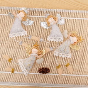 Detail of four Christmas angel ornaments with lace dresses and metallic wings in a basket