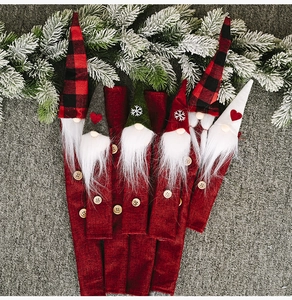 Detailed view of Christmas gnome linen covers with festive embroidery and faux fur beards