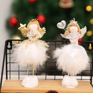 Detail of cute white angel Christmas ornaments with feather skirts and crowns