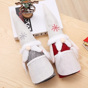 Detail view of two Christmas gnome wine bottle covers with snowflake embroidery and long beards