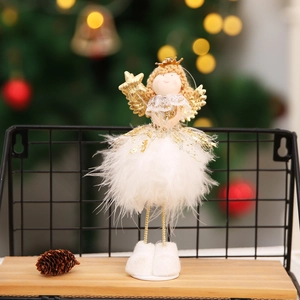 Detail of Christmas angel doll with white feathers, golden wings and a star wand