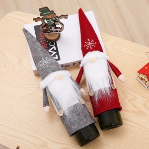 Detail of Christmas gnome wine bottle covers with snowflake embroidery and plush beards