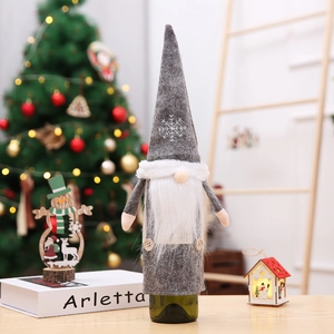 Detail of Christmas gnome wine bottle cover with grey felt hat and snowflake embroidery