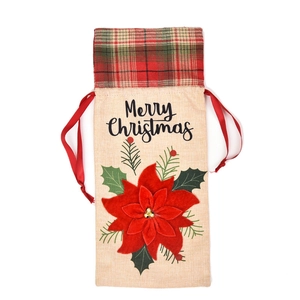 Detail of burlap Christmas wine bag with poinsettia flower and Merry Christmas text