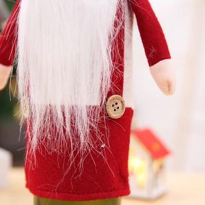 Macro detail of red felt Christmas wine bottle cover with soft white beard and wood buttons