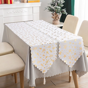 White Christmas table runner with gold foil tree and star patterns and tassels