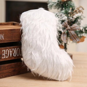 White plush Christmas stocking decoration with fluffy faux fur hanging on a festive tree