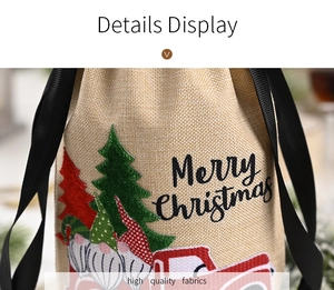 Detailed embroidery of Christmas gnome on linen bottle cover with Merry Christmas text