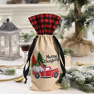 Detail of Christmas wine bottle cover with red truck and plaid linen texture