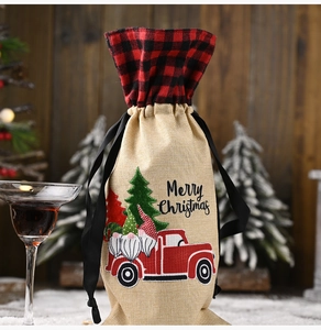 Close-up of burlap Christmas wine bottle bag with red truck and Santa graphics