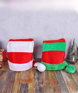 Long plush Christmas hats in red-white and red-green stripes on a wooden floor
