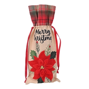 Close-up of Merry Christmas linen wine bag with red plaid trim and 3D floral accent