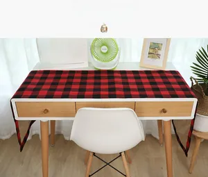 Detail of red and black buffalo plaid table runner with rustic burlap linen backing