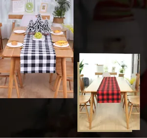 Close-up of red and black buffalo plaid Christmas table runner on a wooden dining table