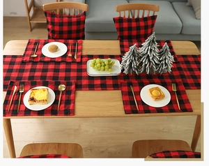 Detail view of red and black buffalo plaid Christmas table runner and placemat set