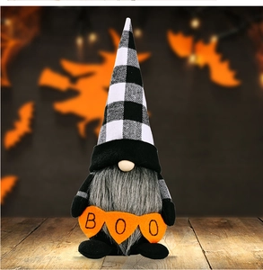 Halloween gnome plush with black and white plaid hat and BOO banner on wood surface