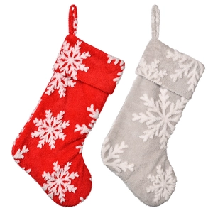 Plush Christmas stockings in red and gray featuring white snowflake patterns for home decor