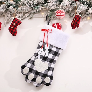 Christmas dog paw stocking in black and white plaid with white faux fur cuff and red bow