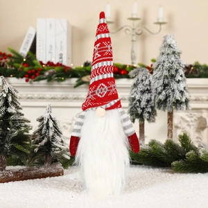 Detail of Christmas gnome wine bottle cover with knitted hat and white beard in festive decor