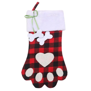 Plaid dog paw Christmas stocking with plush cuff and bone ornaments for holiday decor