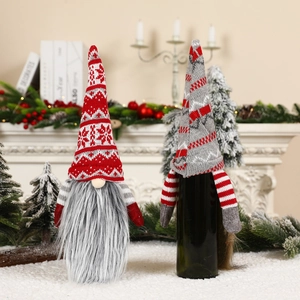 Detail of Christmas gnome wine bottle covers with knitted hats and faux fur beards