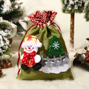 Christmas snowman drawstring gift bag in green burlap with festive holiday scene