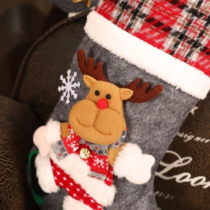 Close-up of grey Christmas stocking featuring a 3D reindeer applique and plush white cuff