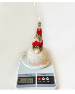 Christmas gnome plush hanging ornament weighing 24.5g on a scale for weight display