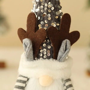 Close-up of a Christmas gnome bottle cover with silver sequins, elk horns and white fur detail