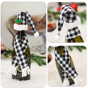 Detailed view of checkered Christmas wine bottle set with mini hat and festive scarf decor