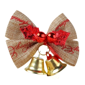 Christmas burlap bow decoration with red holly, gold bells and holiday greeting text