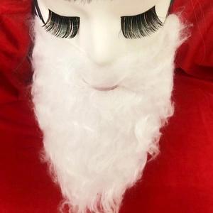 Detail view of a curly white faux fiber Santa beard and black lashes on a model