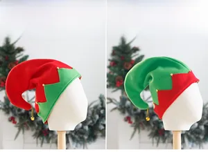 Detail of Christmas elf hats in red and green felt with gold bells for holiday party