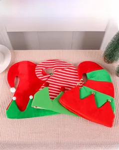 Three festive elf hats with bells and pom-poms displayed on a textured background