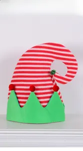 Detail of red and white striped elf hat with green zigzag brim and festive jingle bell