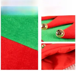 Detail view of red and green festive fabric with golden bells and smooth lining